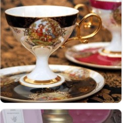 Ornate black and gold teacup
